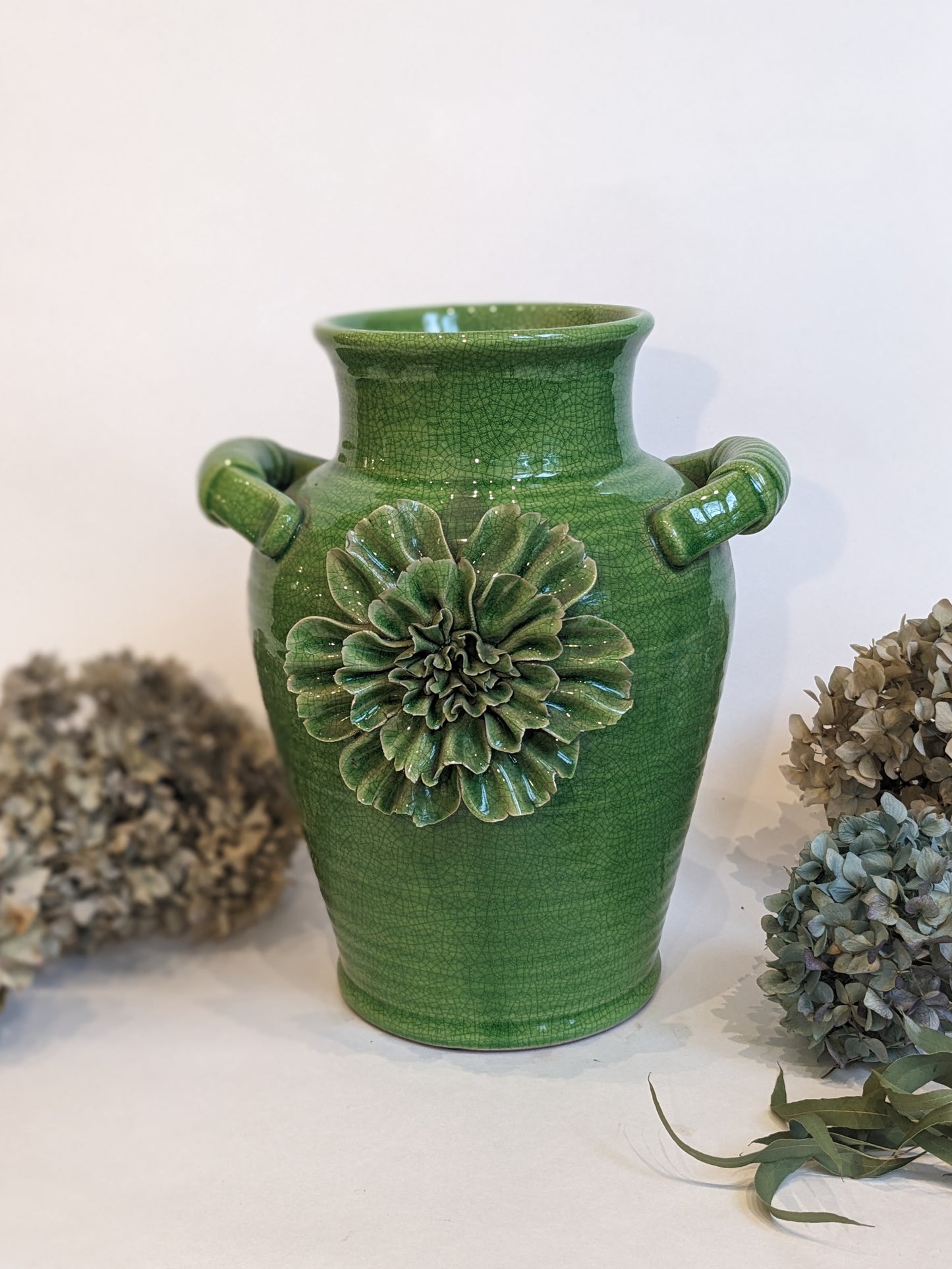 Green Vase With Flower Decoration